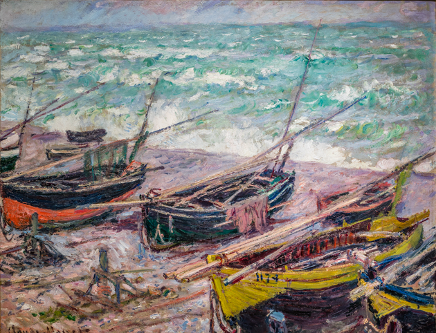 Painterly picture of a number of colorful fishing boats, with water in the background