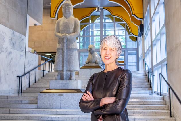 Photo of Amada Cruz, Illsley Ball Nordstrom Director and CEO, standing on the Seattle Art Museum's Grand Staircase