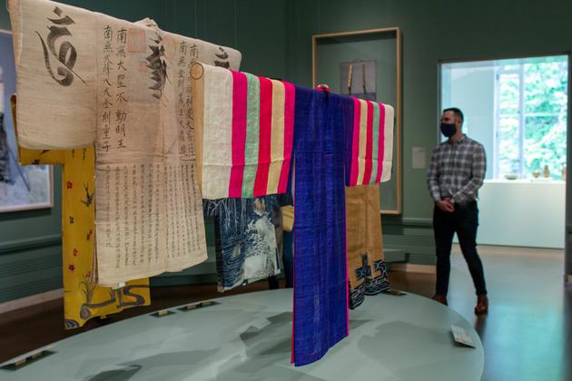 A man looking at a kimono display at the Seattle Asian Art Museum